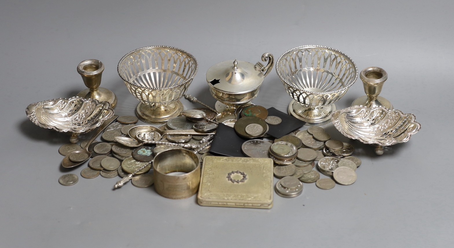 Mixed silver items including a pair of George V pierced silver bowls, weighted, a pair of pierced silver shell dishes, a pair of dwarf candlesticks, a silver napkin ring and other items including compact and assorted coi